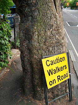 Sign warning motorists of walkers on road